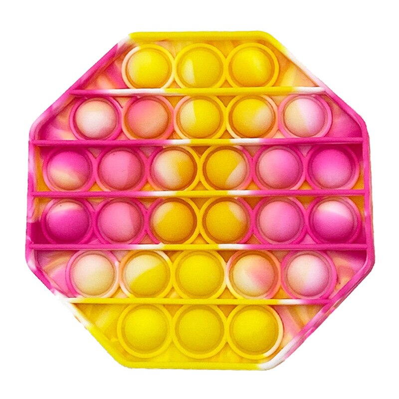 Jouet sensoriel anti stress de forme hexagonale de couleur rose, blanc et jaune.