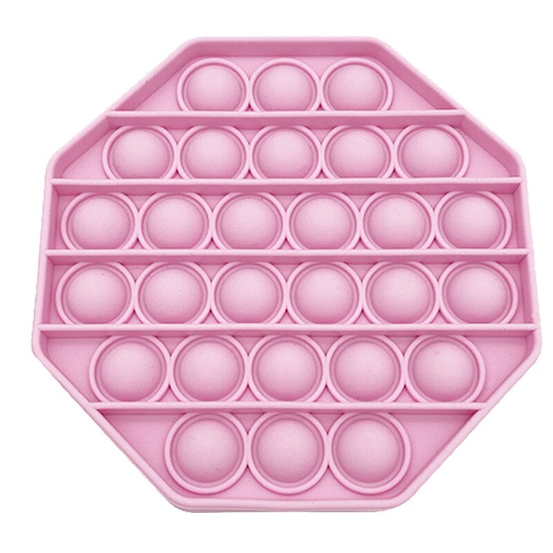 Jouet sensoriel anti stress de forme hexagonale de couleur rose pâle.
