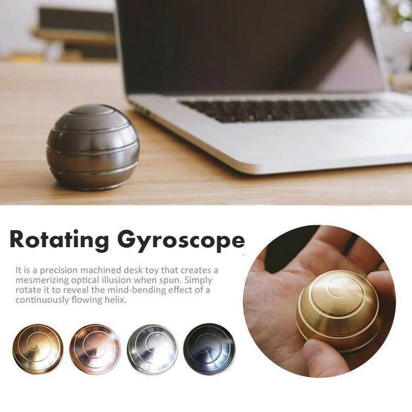 Gyroscope Sphérique Rotative couleur métal posé sur un bureau avec en dessous une image montrant les différentes couleurs du gyroscope rotatif.